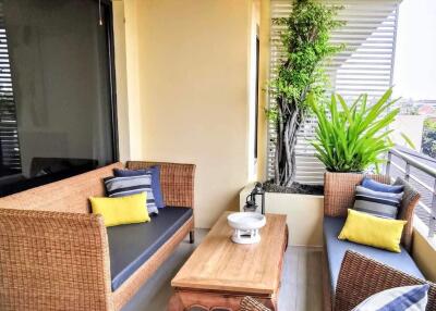 Well furnished balcony with seating and plants