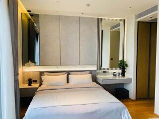 Modern bedroom with double bed, built-in wardrobe, and vanity area