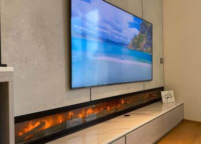 Modern living room with wall-mounted TV and fireplace