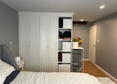 Bedroom with storage cabinets and drawers