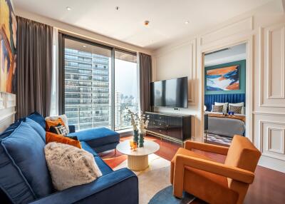 Modern living room with contemporary furnishings and large windows.