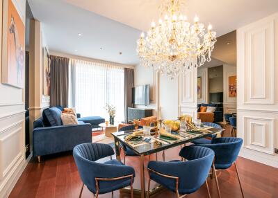 Elegant living room with chandelier and dining area