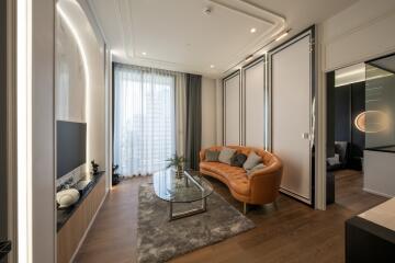 Modern living room with large window, cozy sofa, and glass coffee table