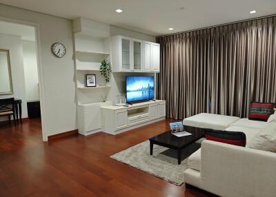 Spacious and modern living room with a large sectional sofa and entertainment area