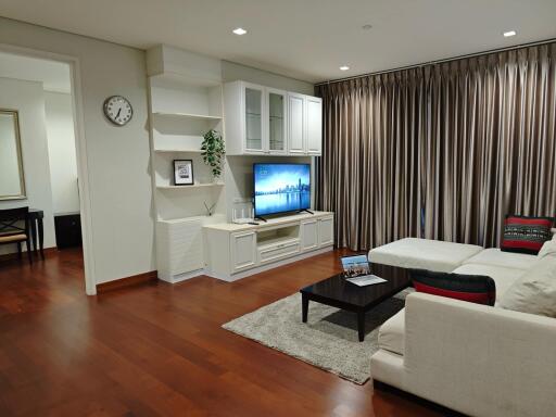 Spacious and modern living room with a large sectional sofa and entertainment area