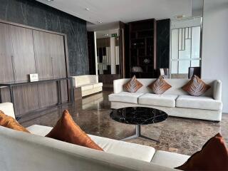 Modern living room with white sofas and marble floor