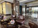 Luxurious building lobby with marble floors and leather seating