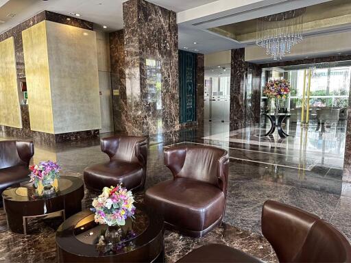 Luxurious building lobby with marble floors and leather seating