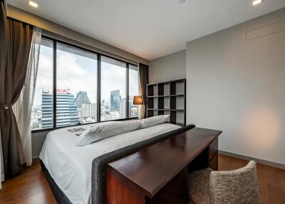 Modern bedroom with large window and city view