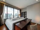 Modern bedroom with large window and city view