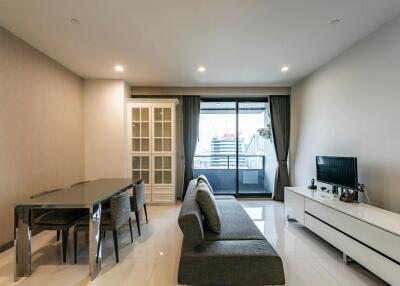 Modern living room with dining area and balcony access