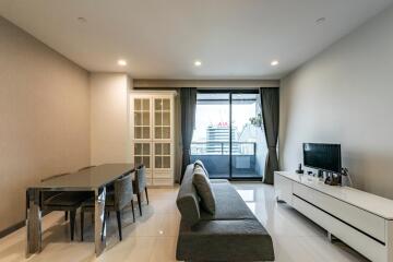 Modern living room with dining area and balcony access