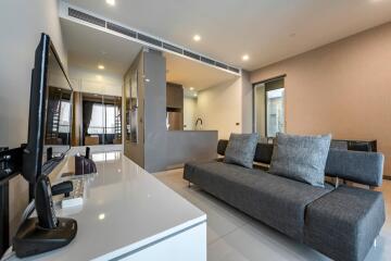 Modern living room with grey couches and a mounted TV