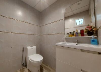 Modern bathroom with white fixtures and decorative tiling