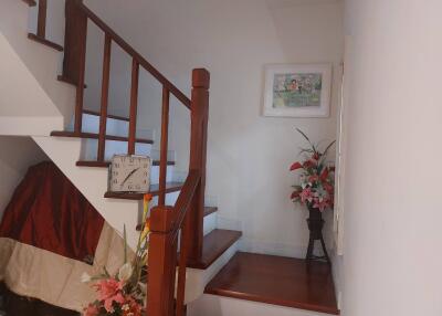 Staircase area with wall art and flower decorations