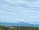 Scenic ocean view with distant islands and lush greenery