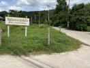 Outdoor area with grassy patch, sign, and power lines