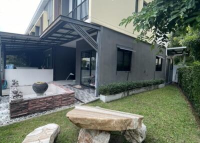 Exterior view of a modern two-story house with patio and garden