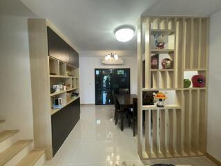 Modern dining area with built-in shelving and contemporary lighting