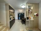 Modern dining area with built-in shelving and contemporary lighting