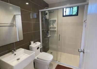 Modern bathroom with glass shower and white fixtures