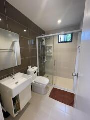 Modern bathroom with glass shower and white fixtures