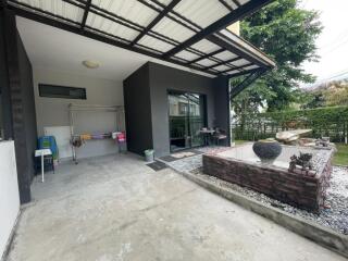 Covered outdoor area with garden and storage