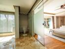 View of modern bathroom and bedroom with glass partitions