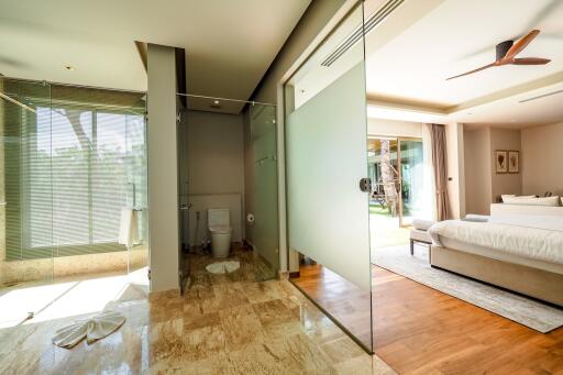 View of modern bathroom and bedroom with glass partitions