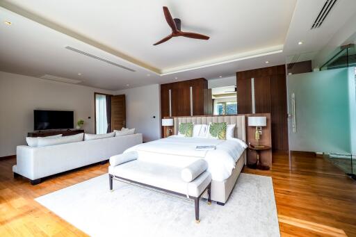 Spacious bedroom with a seating area and modern amenities