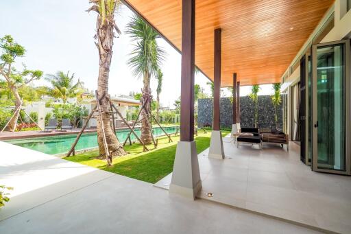 Covered patio area next to a swimming pool