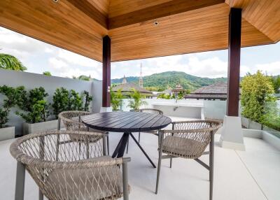 Modern outdoor patio with wooden ceiling and mountain view