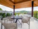 Modern outdoor patio with wooden ceiling and mountain view