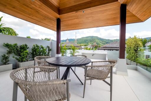 Modern outdoor patio with wooden ceiling and mountain view