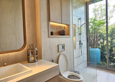 Modern bathroom with glass shower and outdoor view