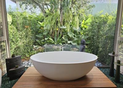 Luxurious bathroom with a freestanding tub and garden view