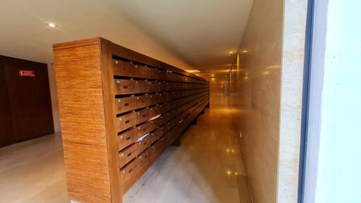 Hallway with multiple wooden mailboxes