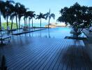 Swimming pool with poolside seating and palm trees