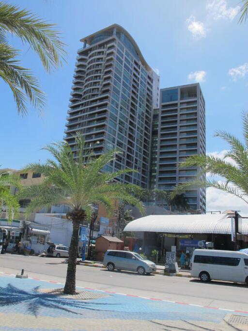 High-rise building exterior with palm trees