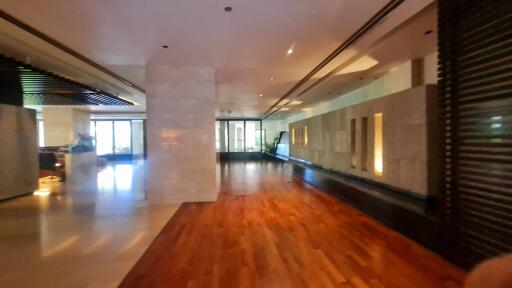 Spacious modern building entrance with wooden flooring