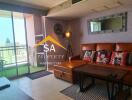 Living room with brown leather sofa, large mirror, and balcony view