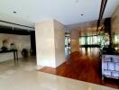 Spacious lobby with wooden and marble flooring