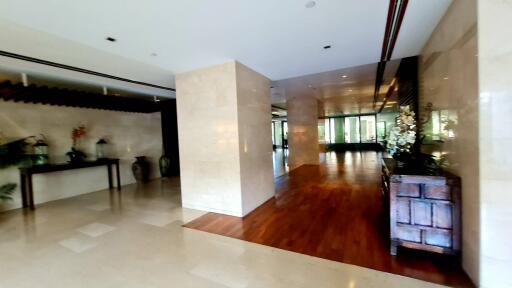 Spacious lobby with wooden and marble flooring