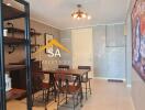 Modern dining area with table and chairs, open shelving, and wall art