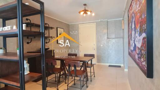 Modern dining area with table and chairs, open shelving, and wall art