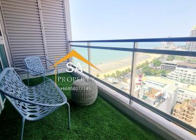 A balcony with a view of the beach and city