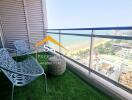 A balcony with a view of the beach and city