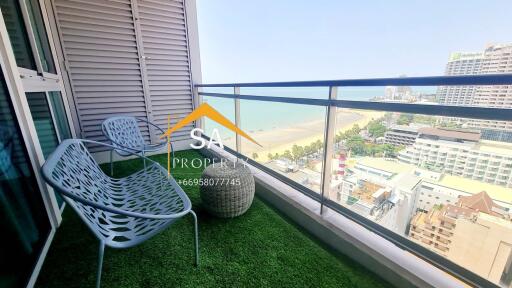 A balcony with a view of the beach and city