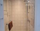 Modern bathroom with tiled walls and glass shower enclosure