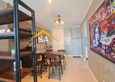 Modern dining area with industrial-style shelving and artwork